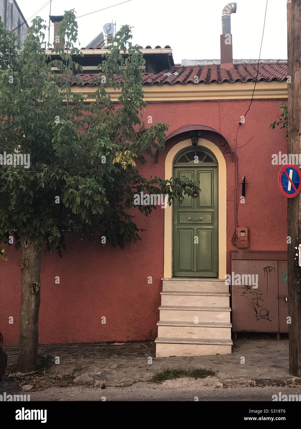 Red house, green door Greece - Smartphone Captured Stock Image