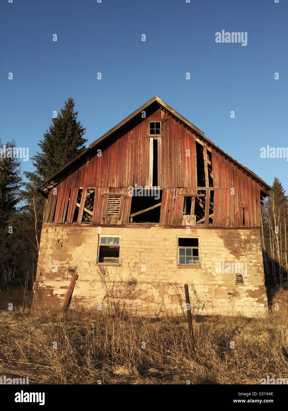 Abandoned and declined old wooden barn in the Swedish countryside. - Smartphone Captured Stock Image