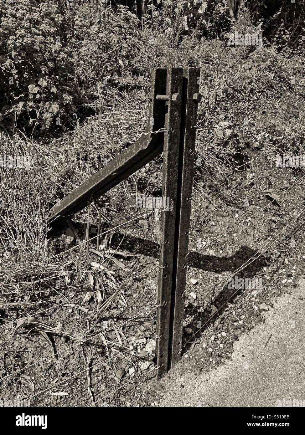 Broad-gauge rail of the type once used by the Great Western Railway in use as a fence post in Yatton, UK - Smartphone Captured Stock Image
