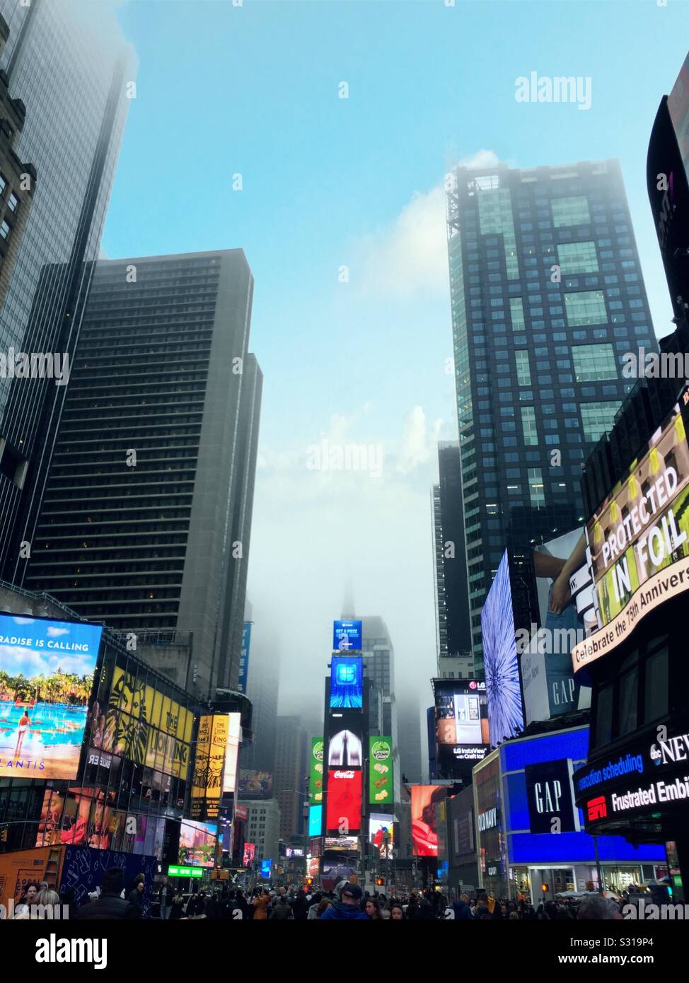 Times square or Tronic billboards and skyscrapers on a foggy evening, NYC, USA - Smartphone Captured Stock Image