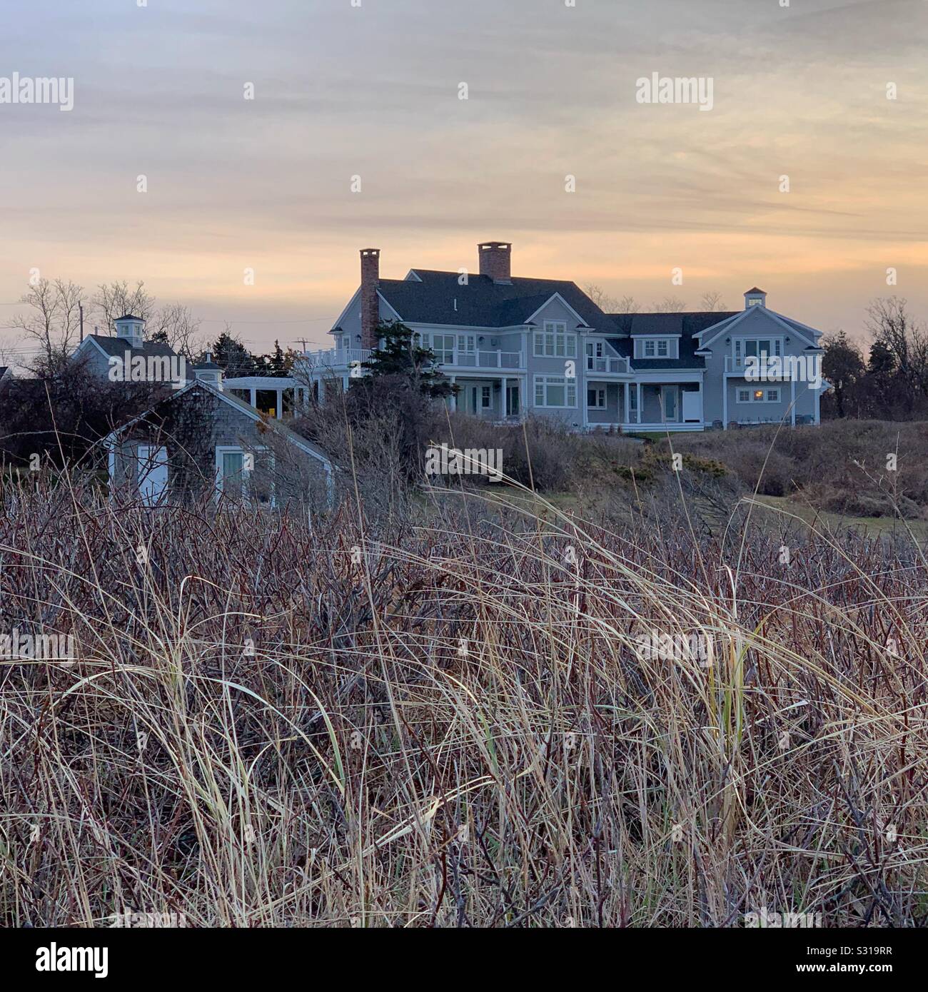Sunset at a house on the beach, Cape Cod, Massachusetts, United States - Smartphone Captured Stock Image