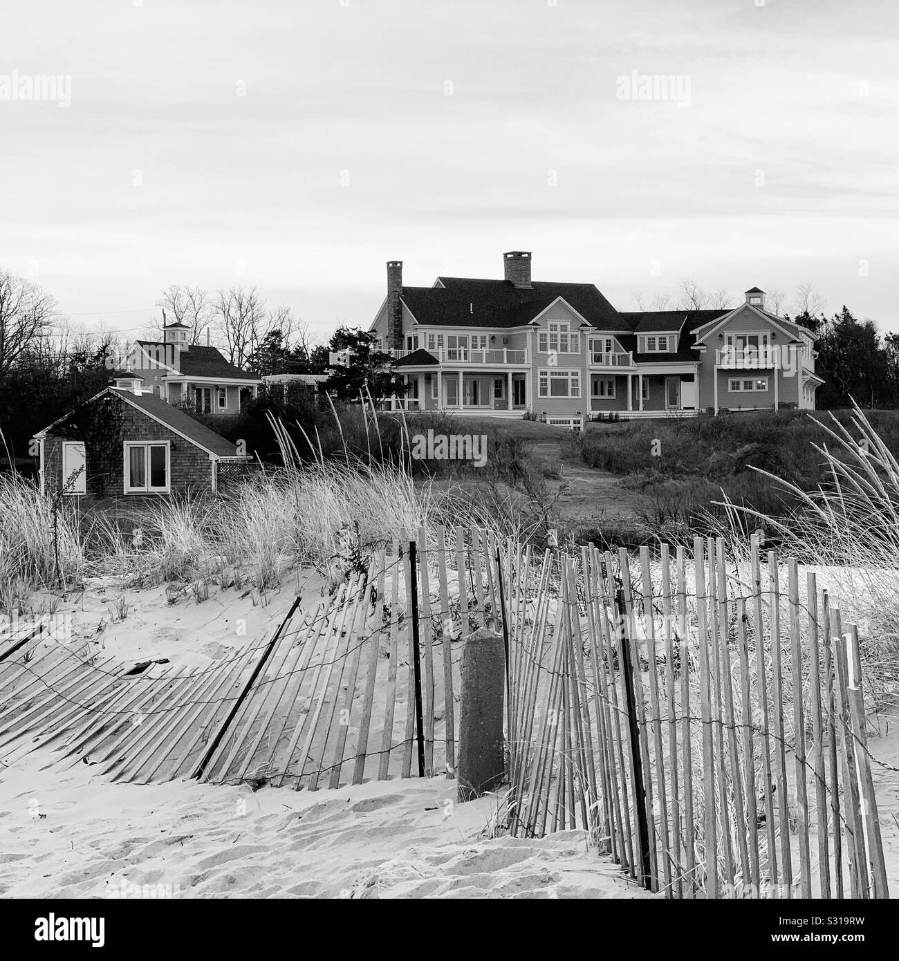 Black and white image a large home on the beach, Cape Cod