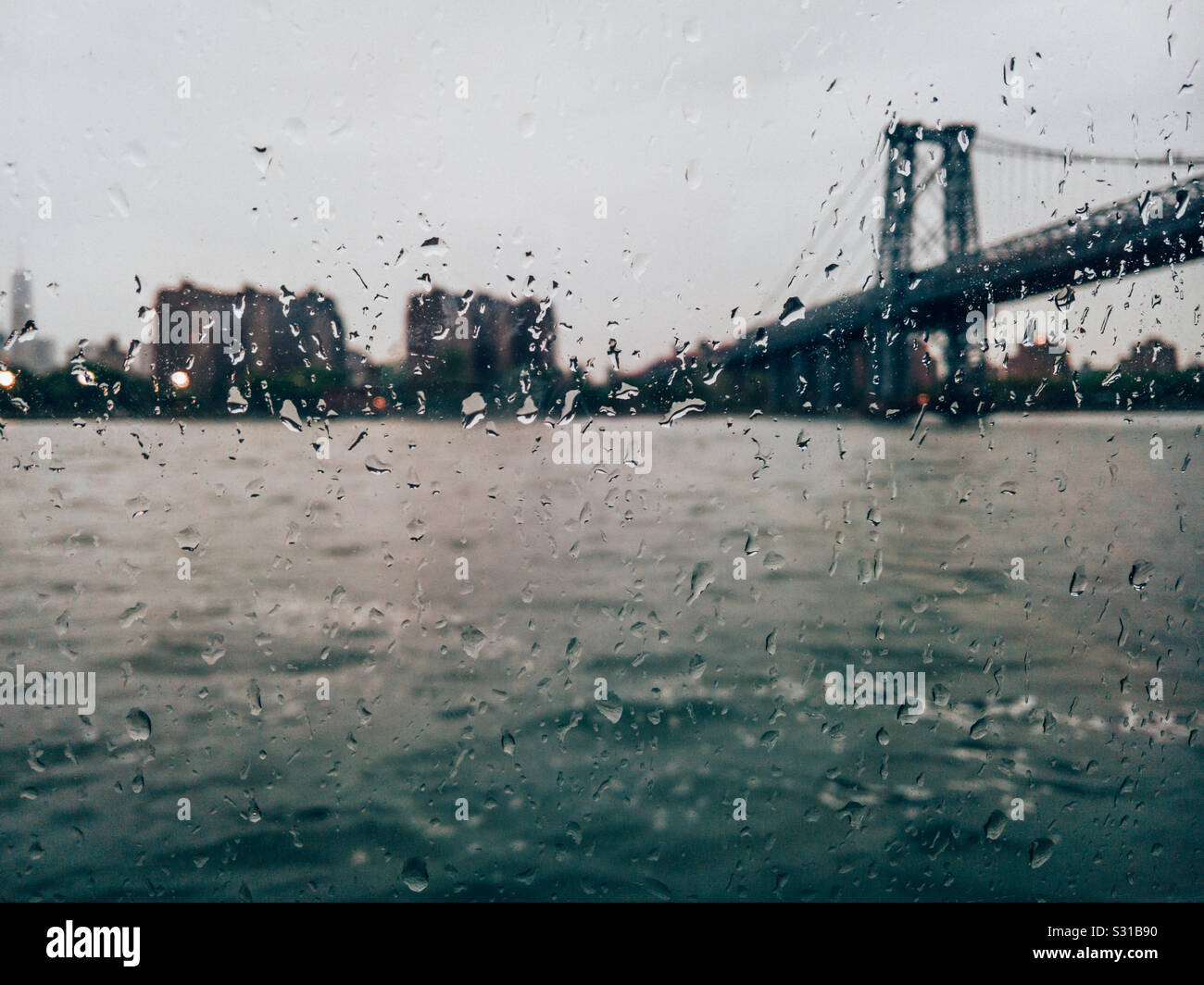 East river Ferry Underneath the Williamsburg bridge  on a rainy day - Smartphone Captured Stock Image