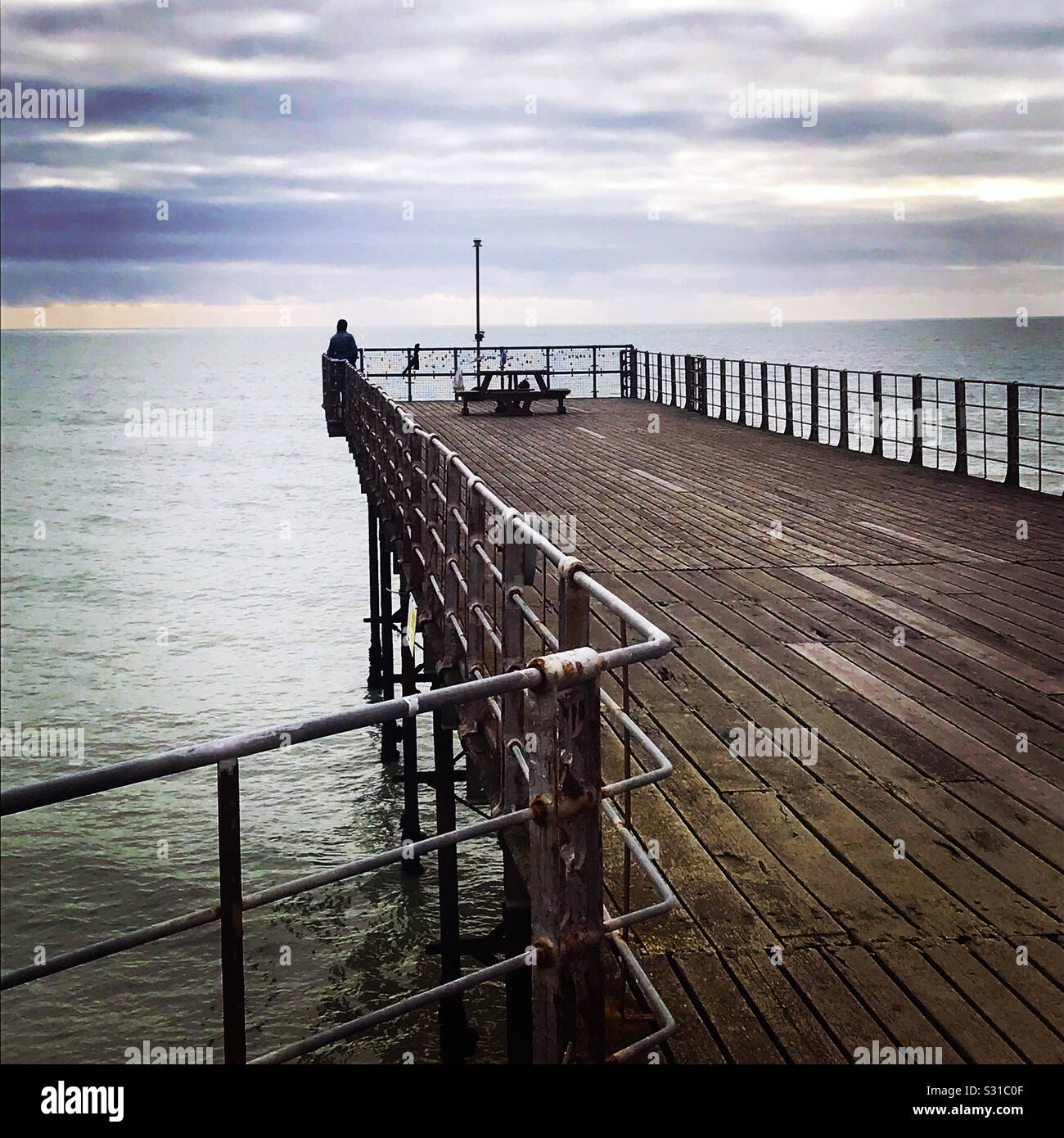 Seaside pier view of the sea with dramatic clouds - Smartphone Captured Stock Image