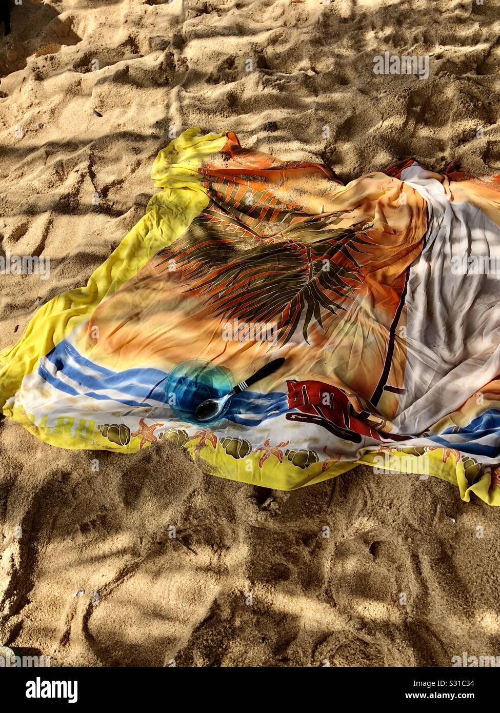Surfers Discarded Beach Wrap in the Leafy Shadows of a Secluded Beach Hut, RJ, Brazil Stock Photo