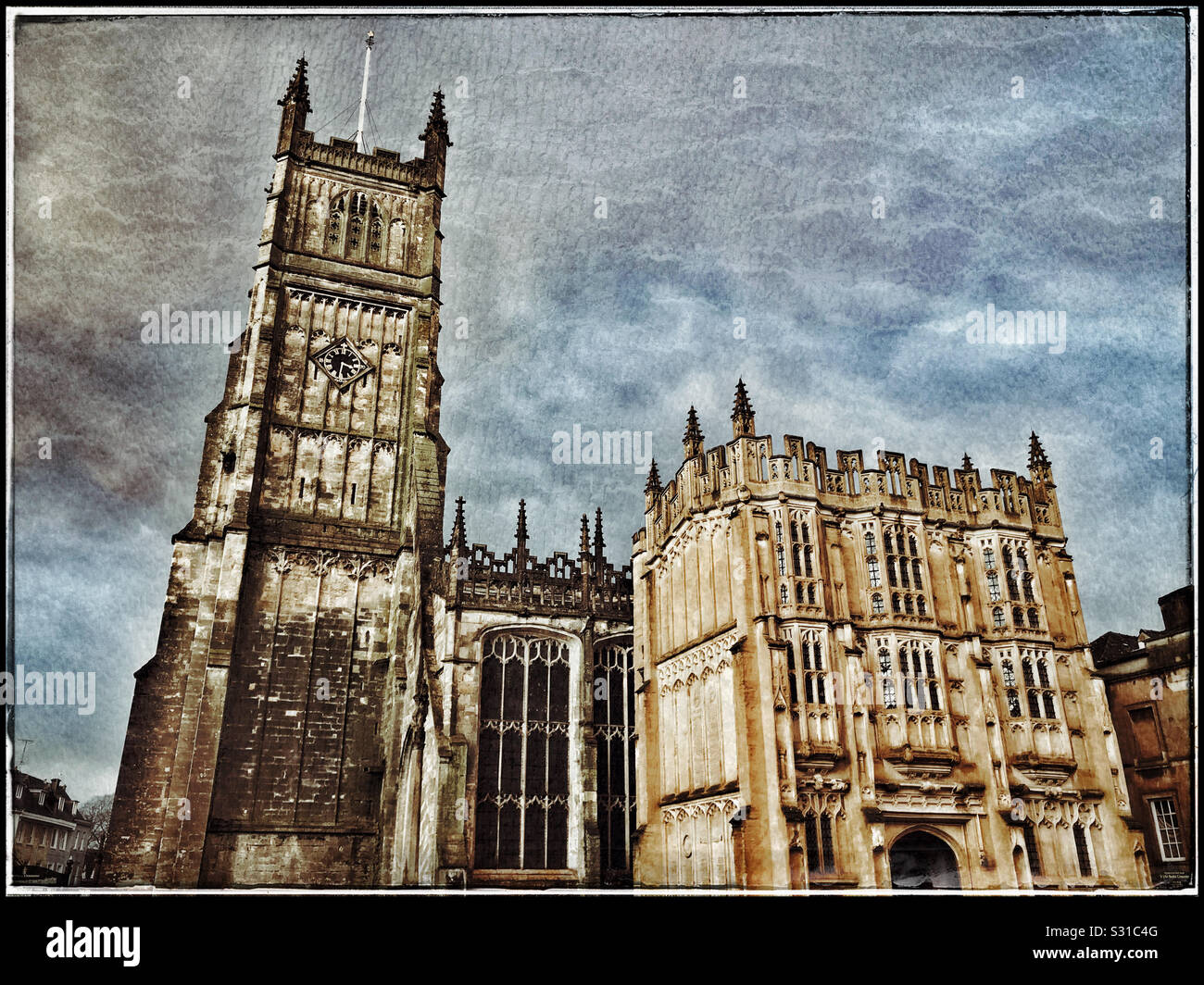 A retro view of the famous Anglican St. John Baptist Parish Church in Cirencester, Gloucestershire, England. A good starting point to explore the Cotswold region. Photo Credit - © COLIN HOSKINS. Stock Photo