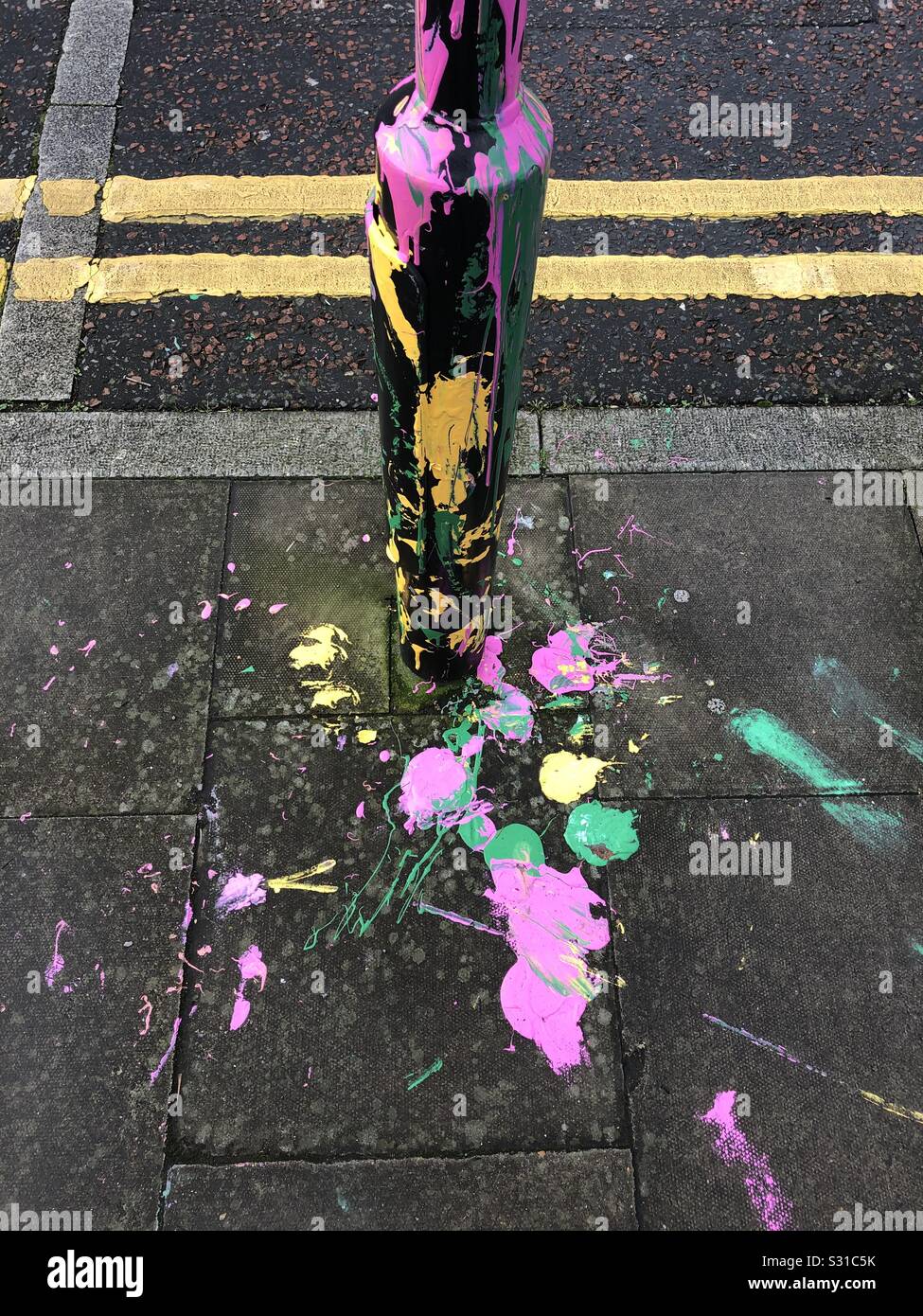 Colourful paint splashed on a lamp post in London UK - Smartphone Captured Stock Image