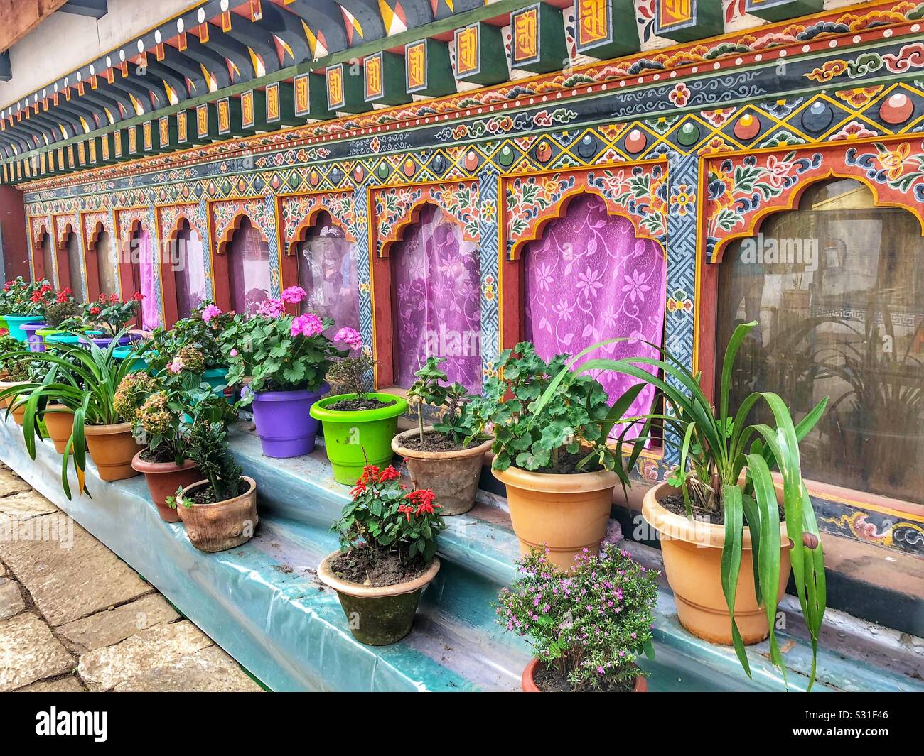 Planters decorate the courtyard of a Buddhist monastery in Bhutan. Stock Photo