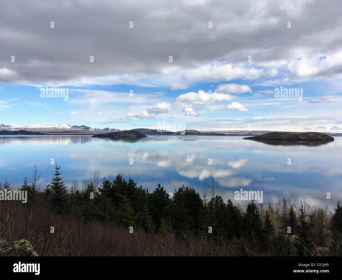Cloud reflections in a lake in Iceland Stock Photo - Alamy