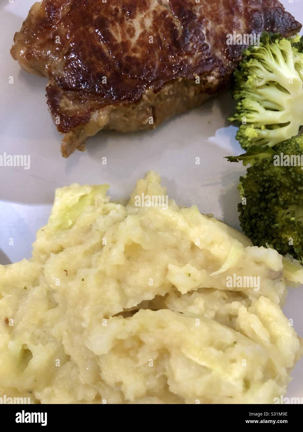 Closeup of steak with mash potatoes and broccoli. - Smartphone Captured Stock Image
