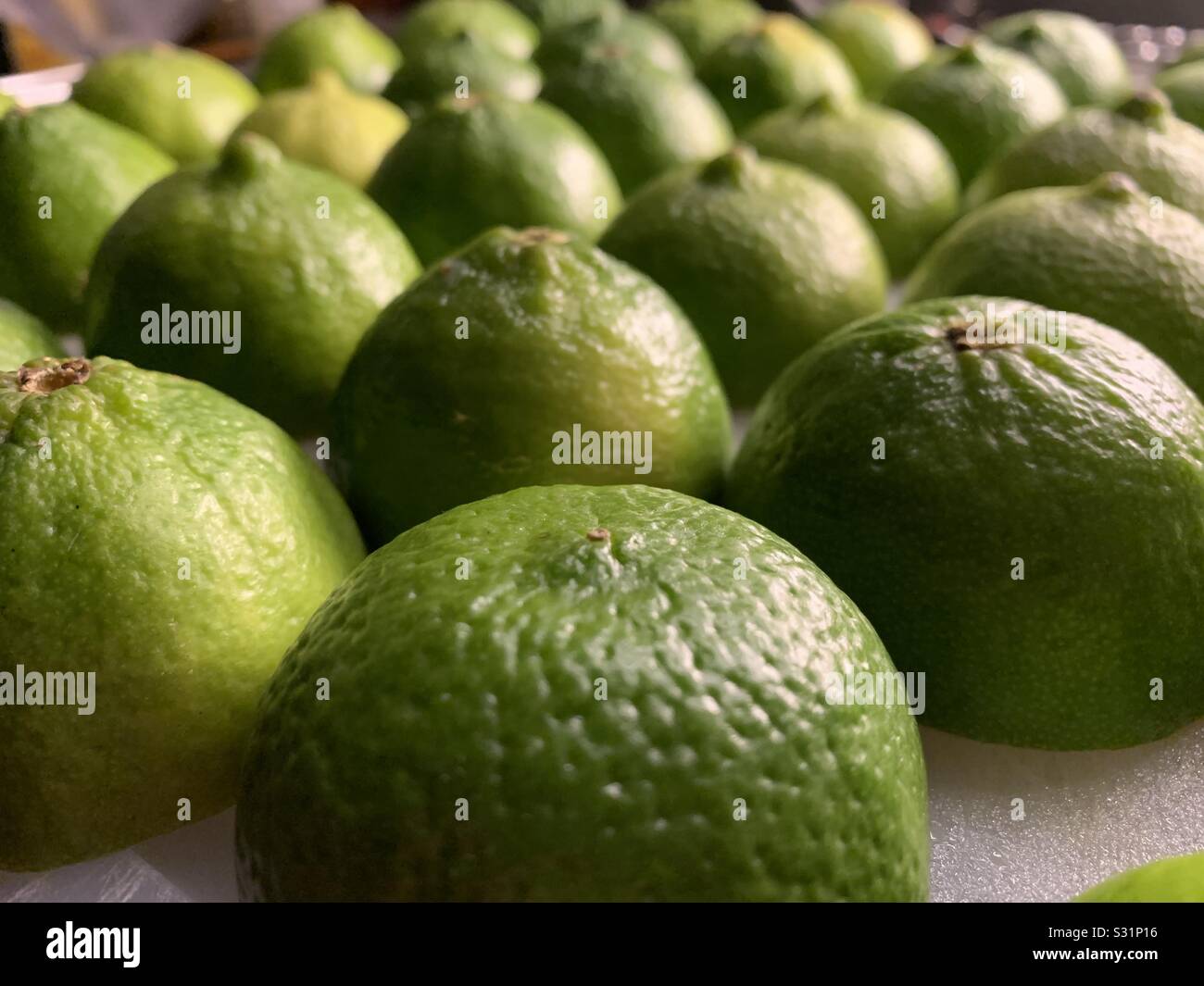 Limes cut in half Stock Photo Alamy