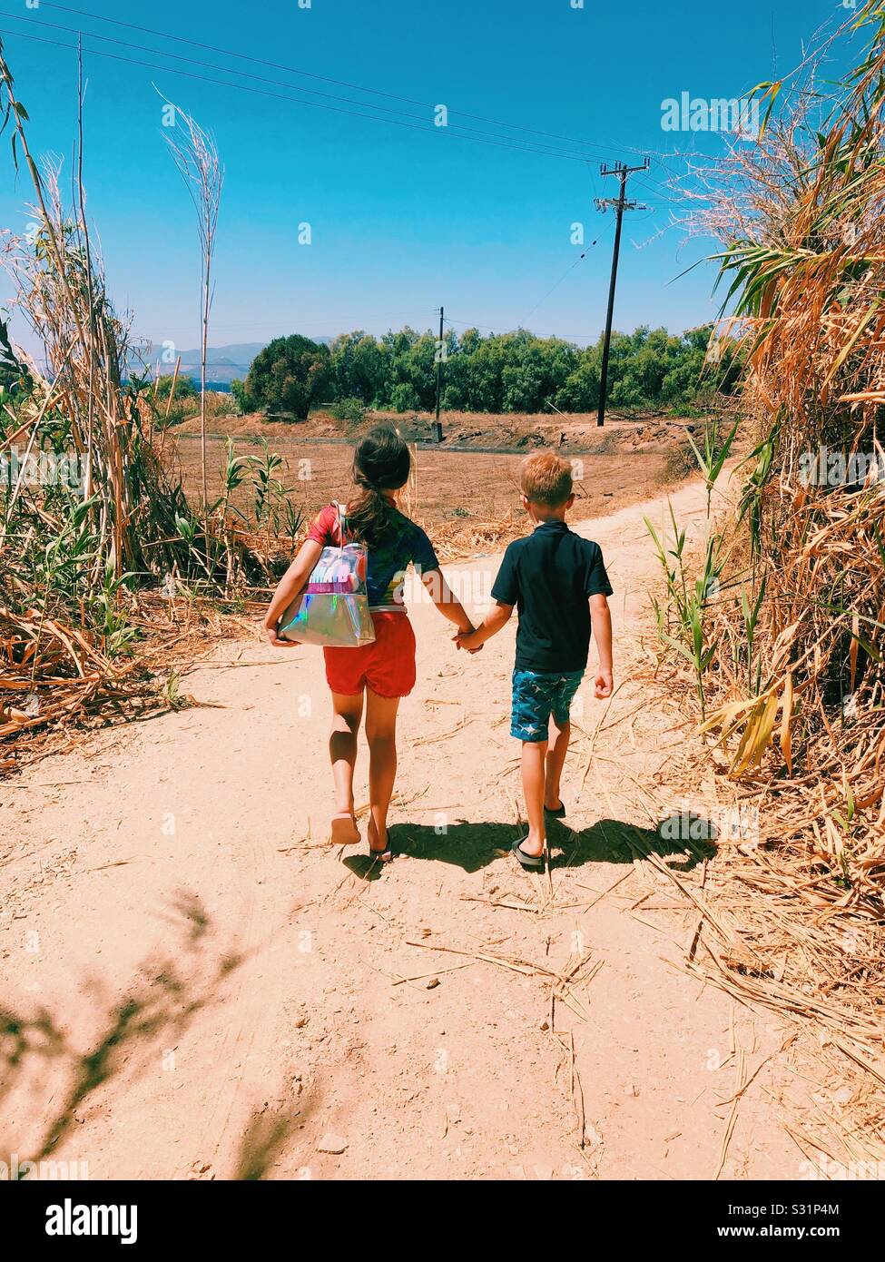 Boy and girl walking holding hands hi-res stock photography and images ...