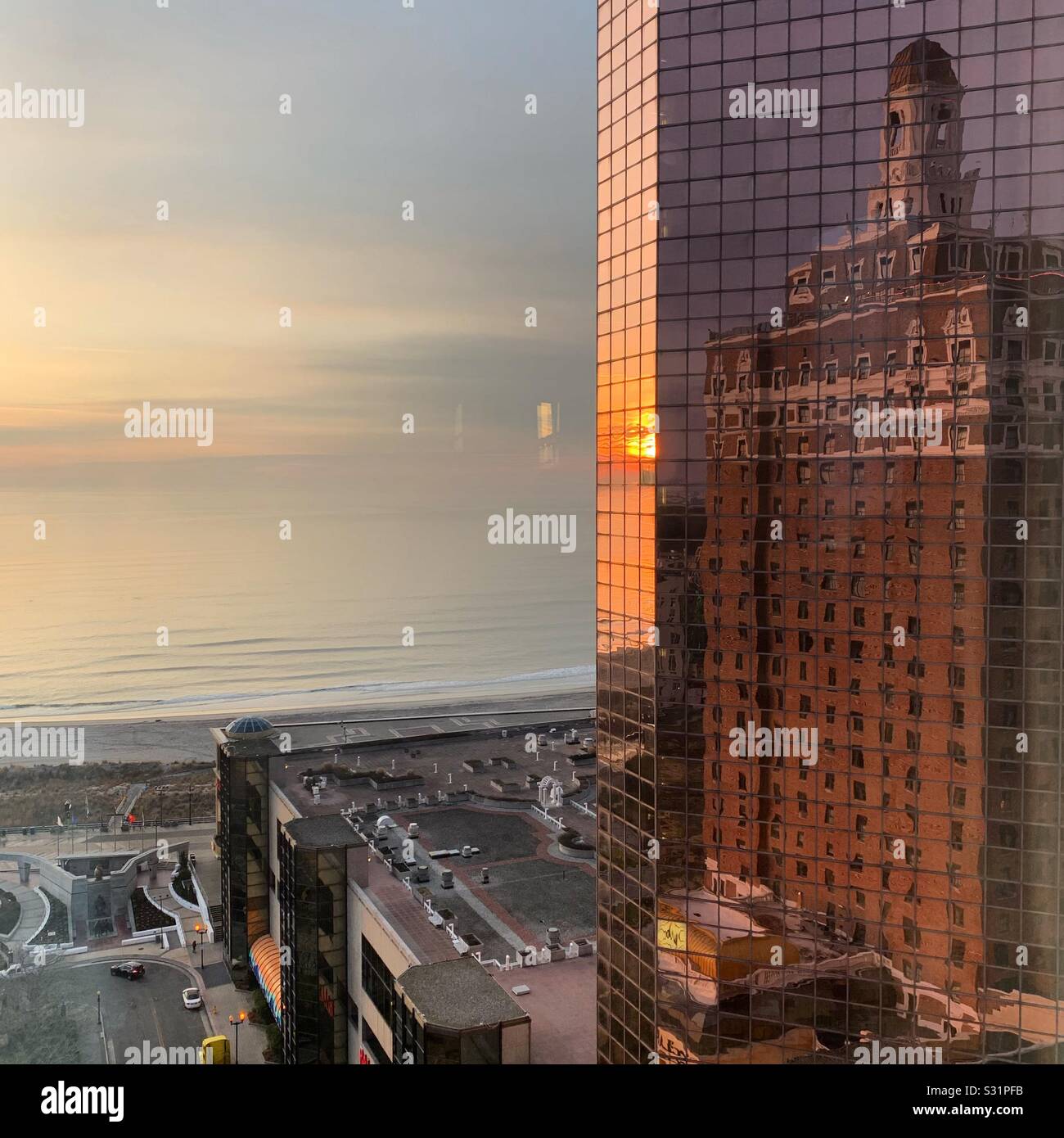 The Claridge Hotel reflected in Bally’s Casino Resort early in the morning, ocean in the background, Atlantic City, New Jersey, United States - Smartphone Captured Stock Image