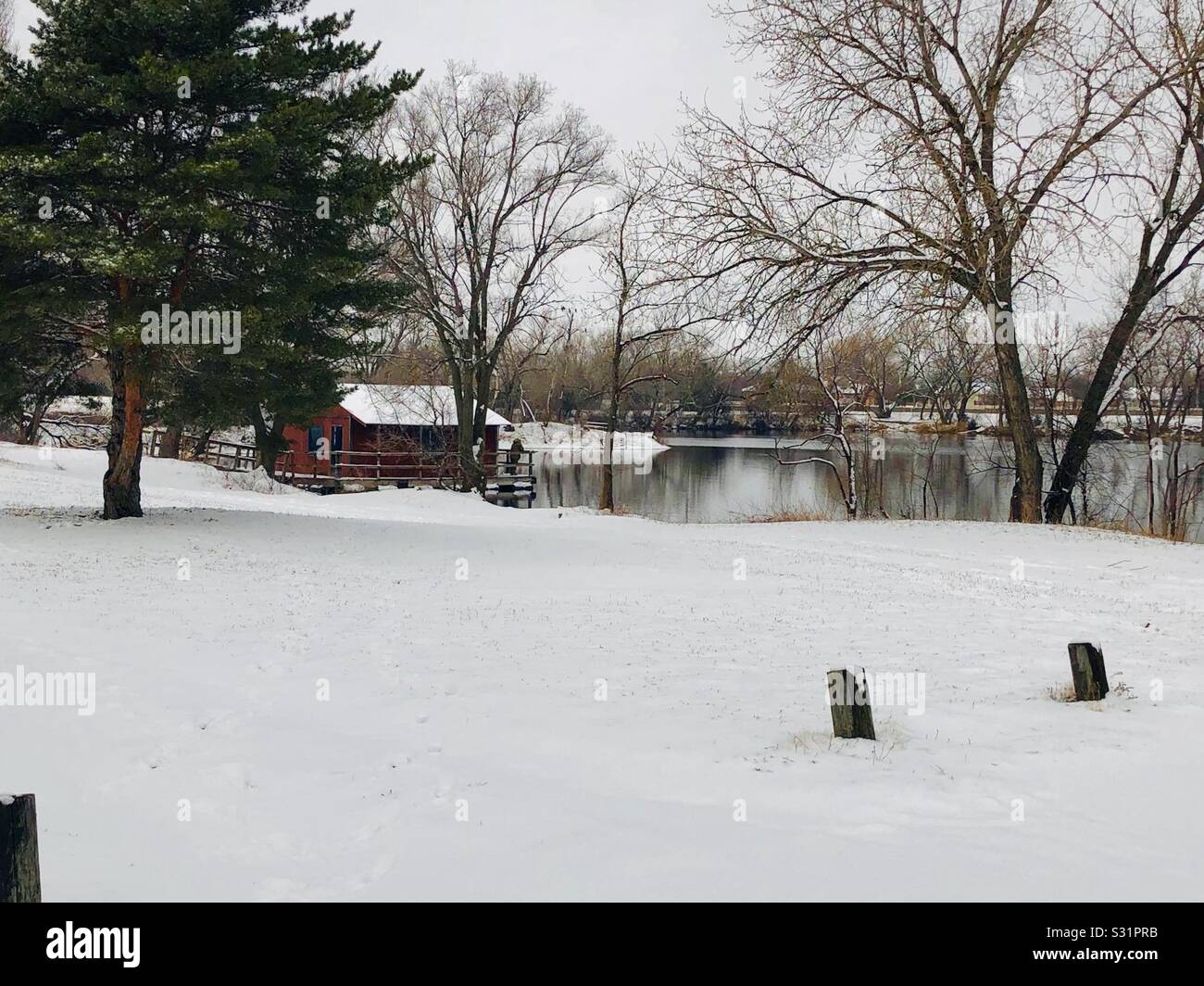 Pond and fishing dock in the snow. - Smartphone Captured Stock Image