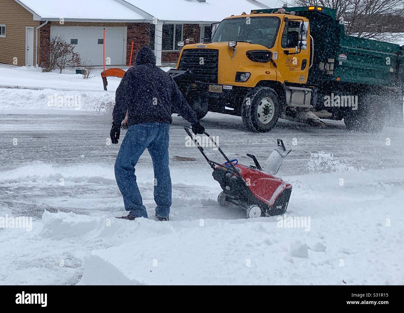 Dubuque, Iowa, 01/11/19closeup photo of man using red snow thrower