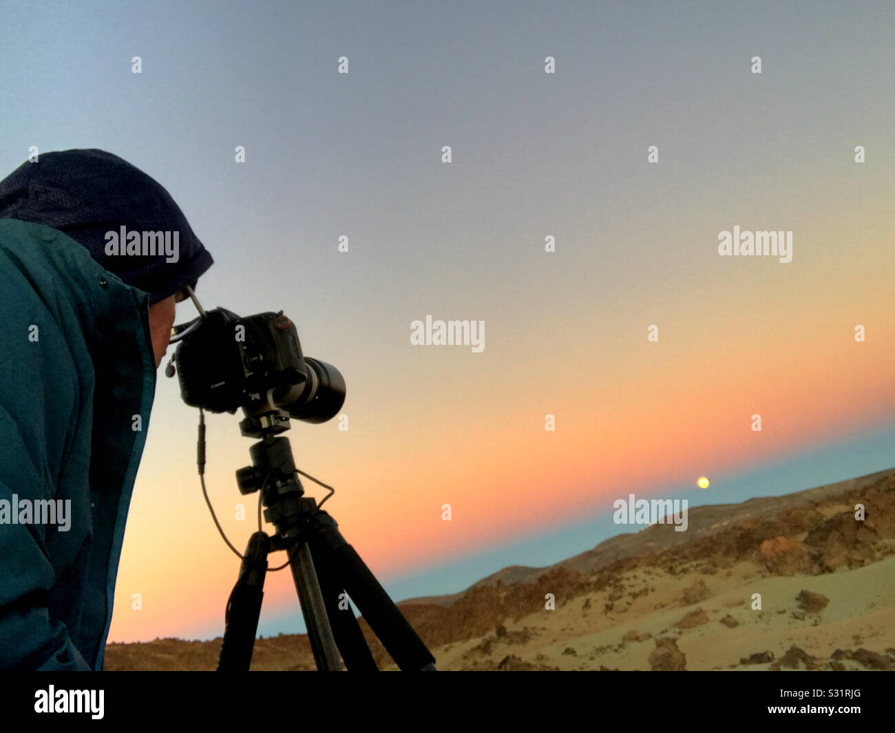 Photographer shooting the full moon in the volcanic landscape of las Canada’s del Teide, Tenerife - Smartphone Captured Stock Image