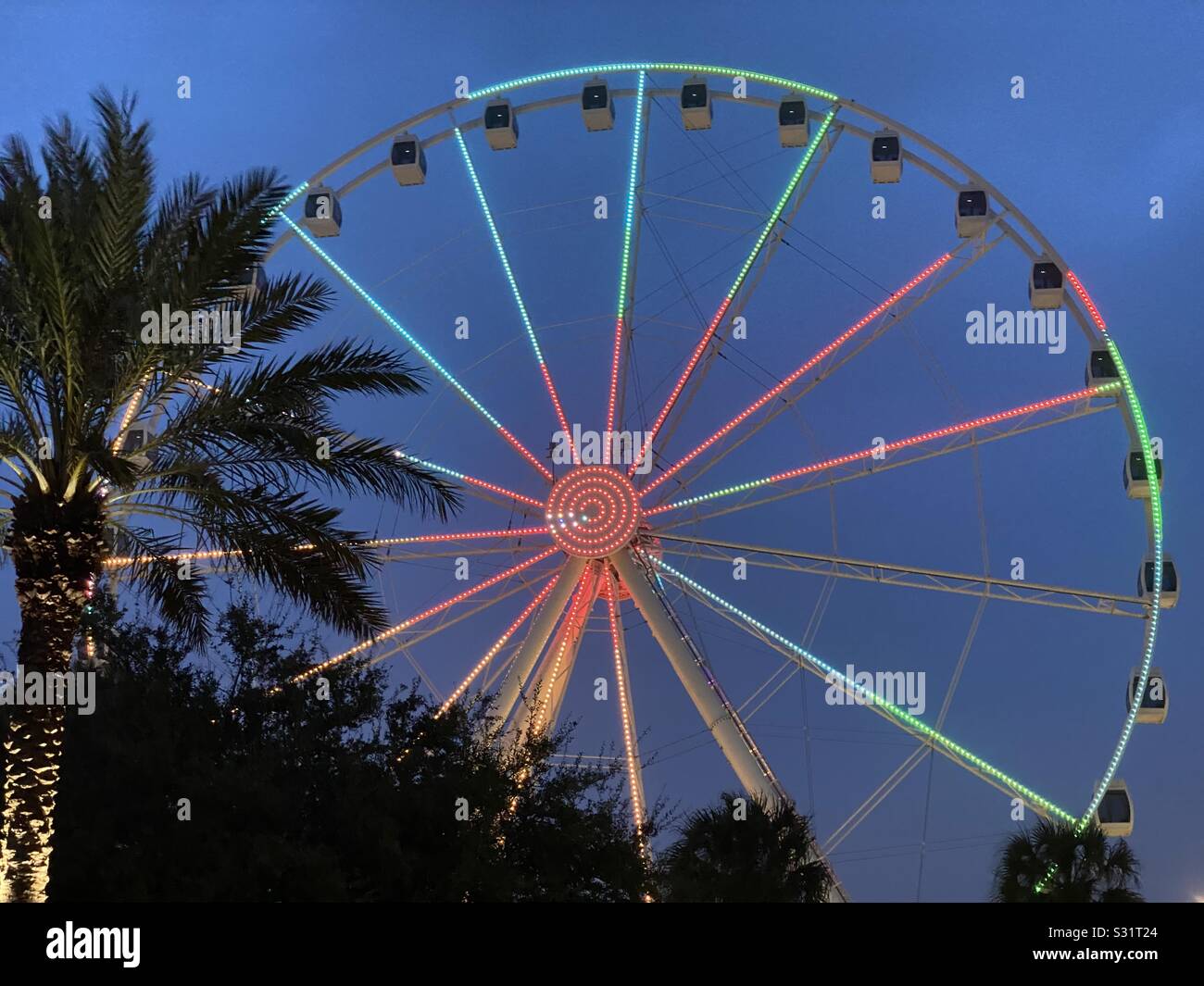 Sky wheel lit up at nighttime Stock Photo - Alamy