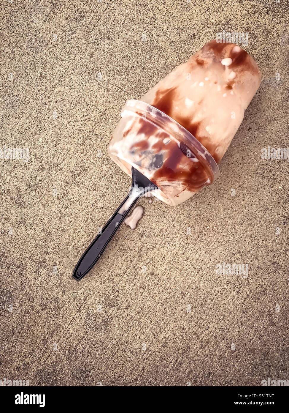 Ice cream cup on a concrete ground Stock Photo Alamy