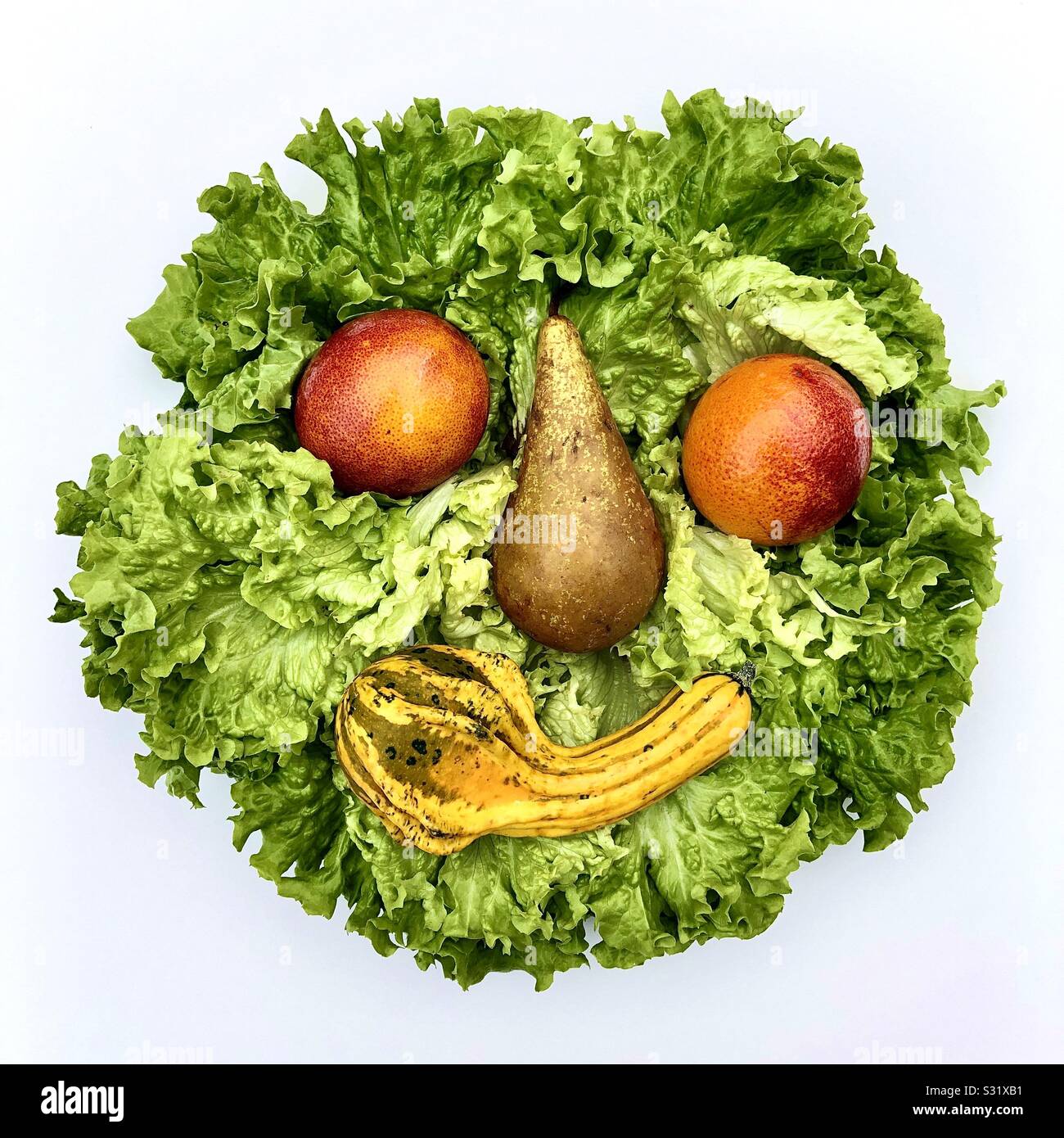Happy « smiley » face made with fruits and vegetables. Stock Photo