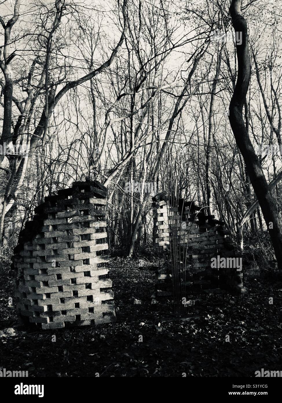 Sculpture in the woods made from biodegradable bricks Stock Photo