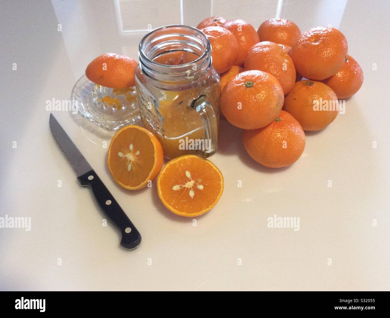 refreshing vitamine C drink with tangerine juice in glass on a white background Stock Photo