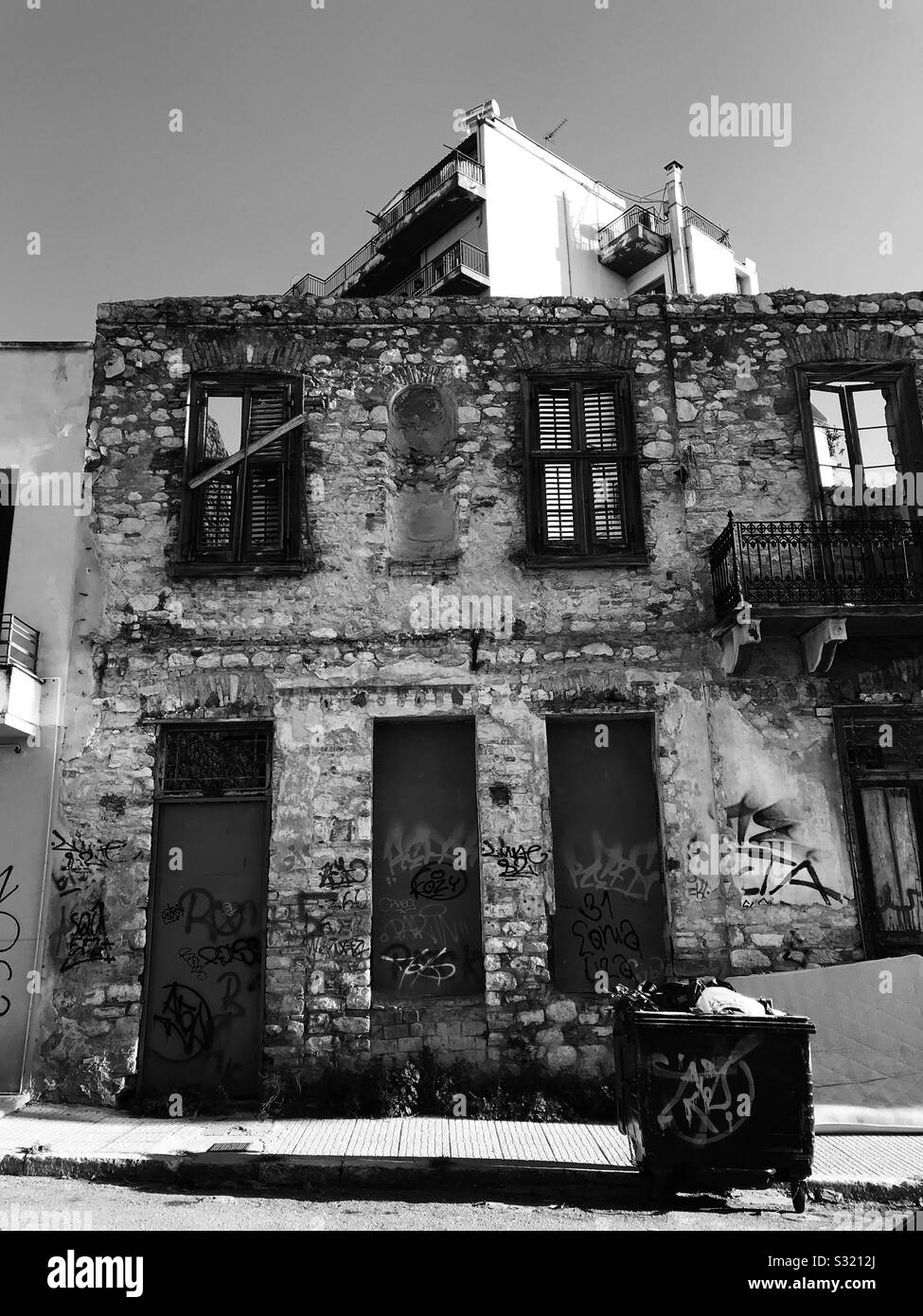 Exterior shell of abandoned house with graffiti. Patras Greece.Black and White - Smartphone Captured Stock Image