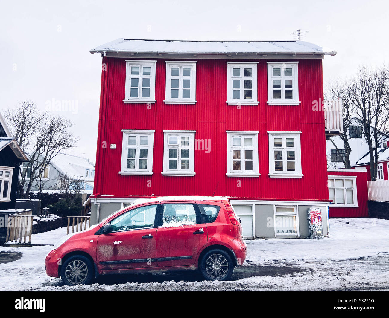 A red house and red car in Reykjavik, Iceland on December 10, 2019. - Smartphone Captured Stock Image