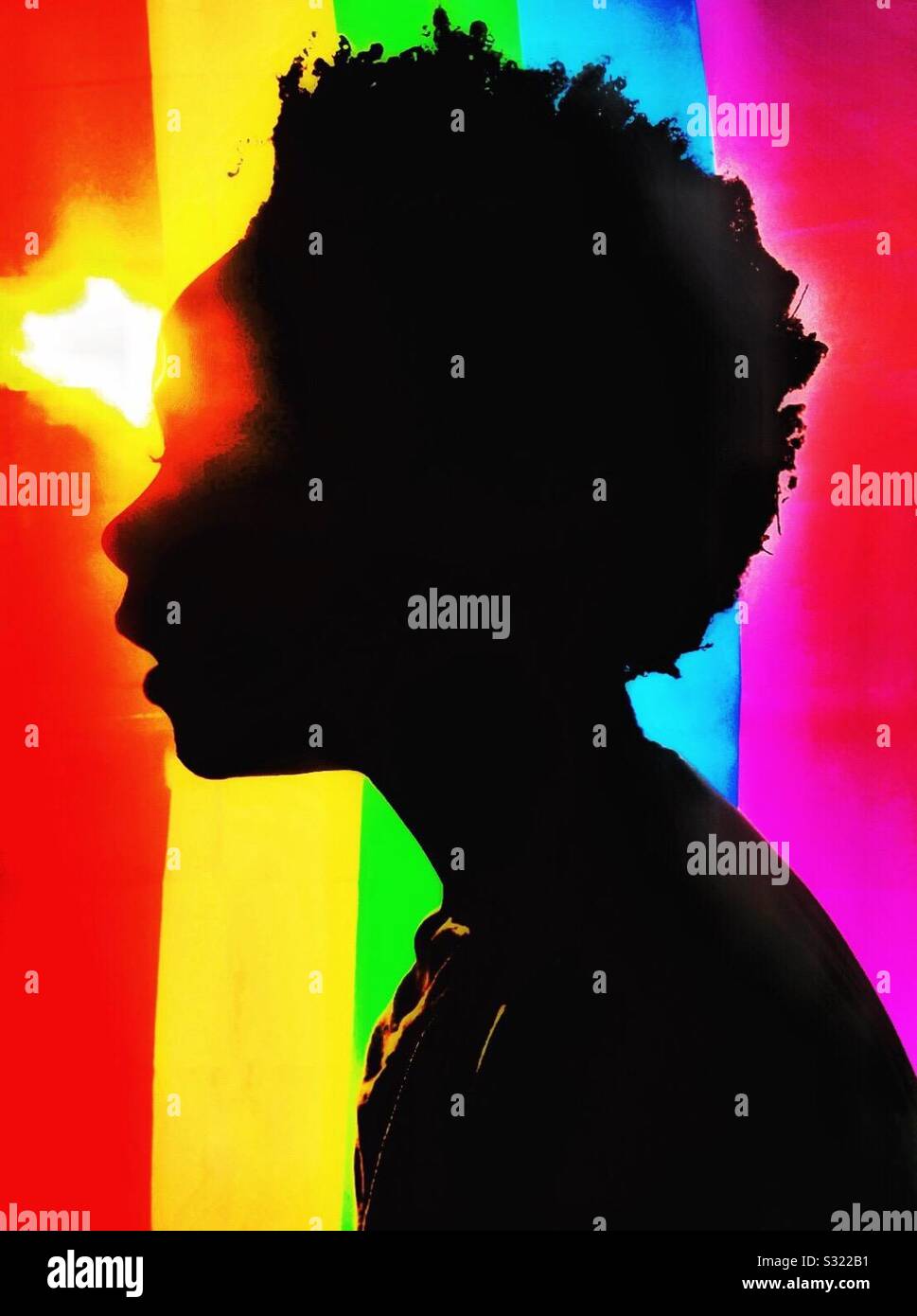 Silhouette of a child and a rainbow flag. Stock Photo