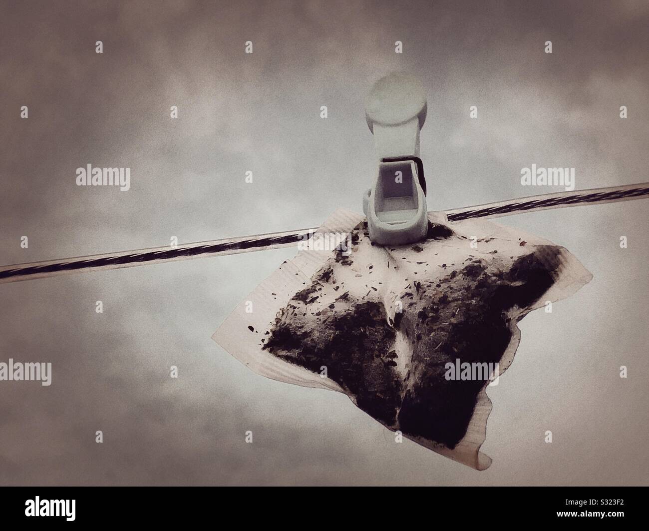 A teabag hanging out to dry on a clothesline - Smartphone Captured Stock Image
