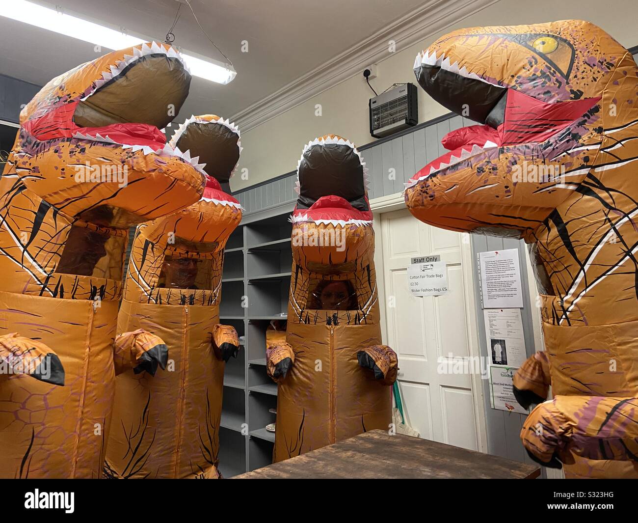 T. rex dinosaurs standing in a bakery - Smartphone Captured Stock Image