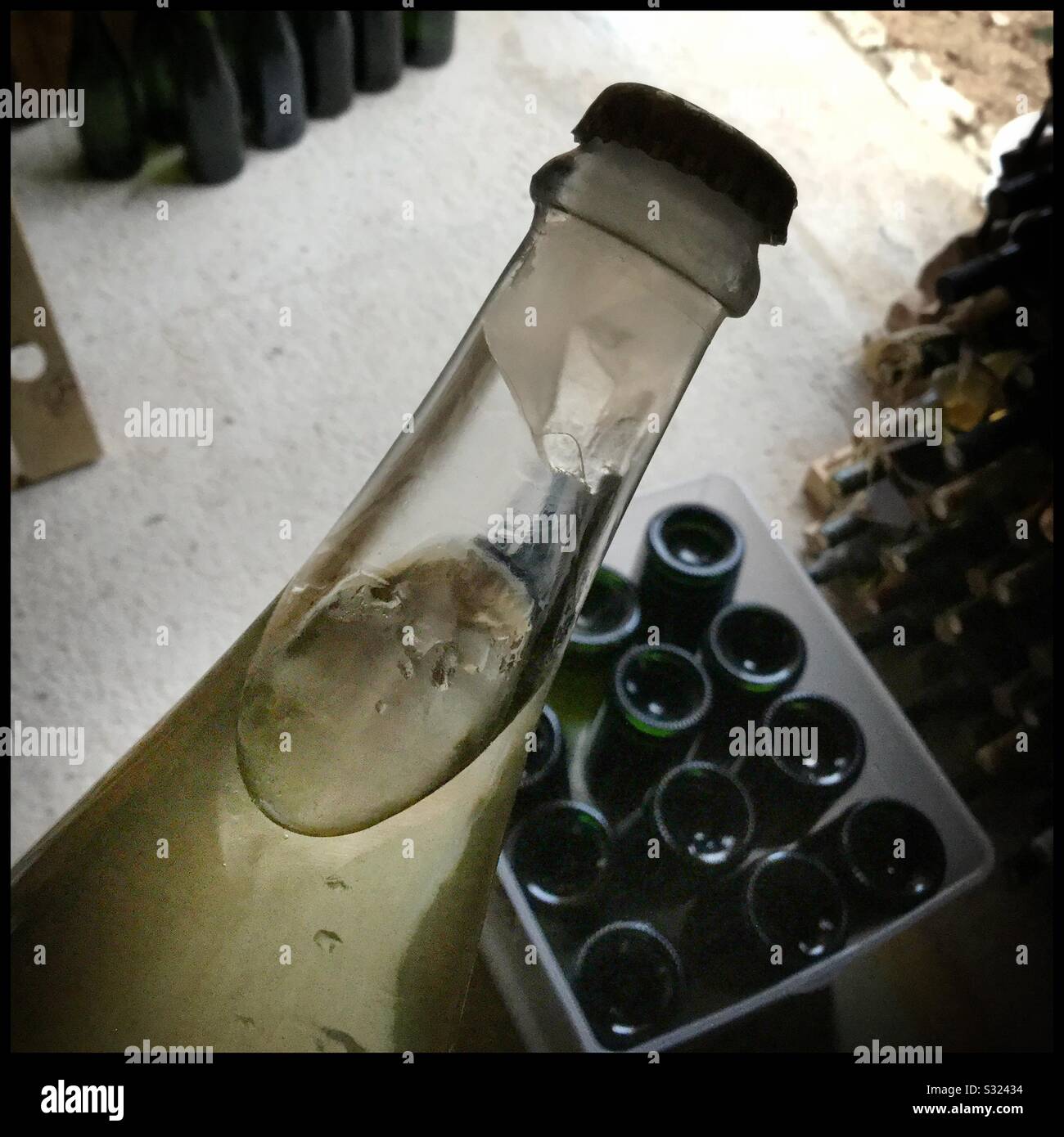 Freezing the neck of a sparkling wine bottle prior to