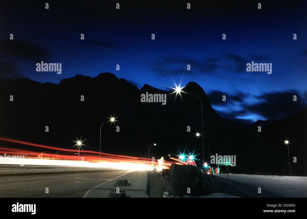 Early morning, taillights, Transcanada highway, Canadian Rockies,  Banff National Park, Alberta, Canada Stock Photo