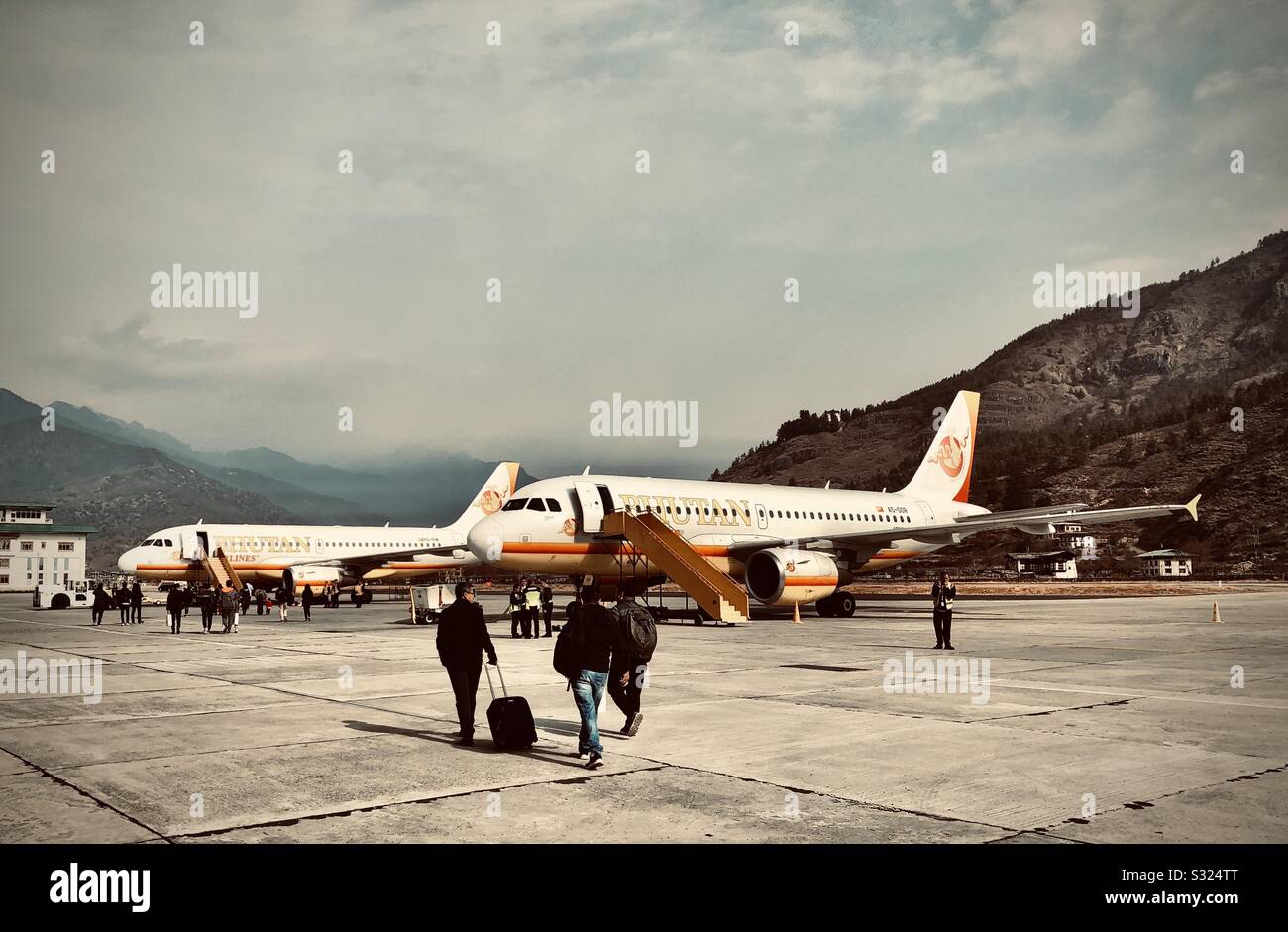 Passengers boarding a Bhutan airlines flight at Paro airport, Bhutan - Smartphone Captured Stock Image