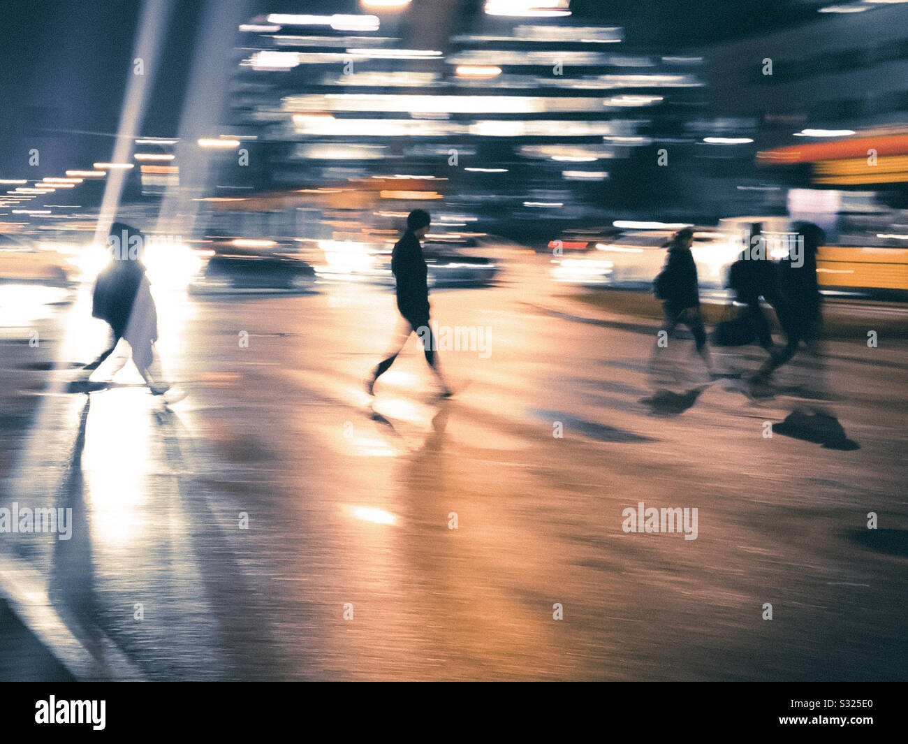 People silhouettes crossing. a busy street. Stock Photo