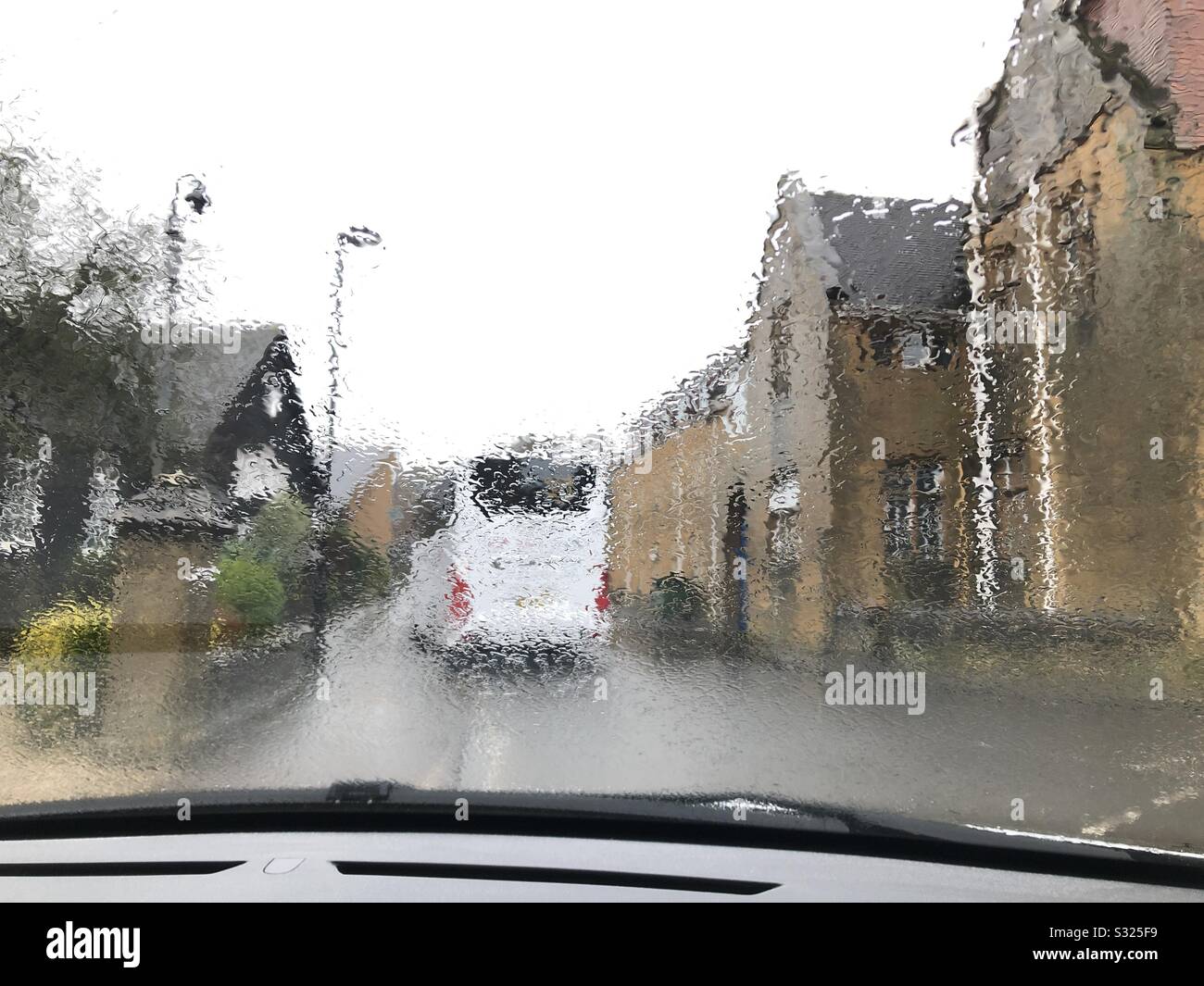 Coach in the rain, seen through car windscreen - Smartphone Captured Stock Image