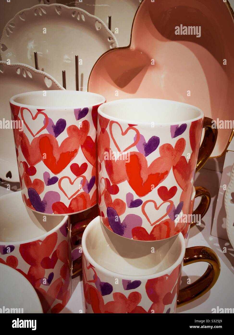 Festive heart themed Saint Valentine’s Day mugs on sale at a retail shop in the United States of America - Smartphone Captured Stock Image