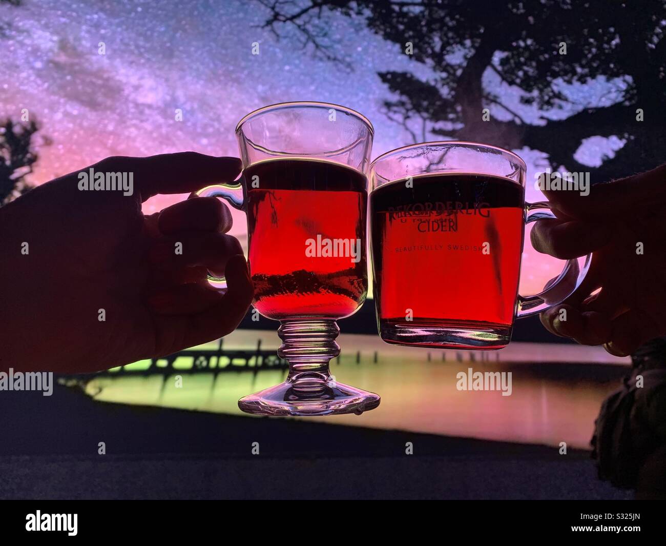 Cheers with a glass of mulled cider in glass cups - Smartphone Captured Stock Image