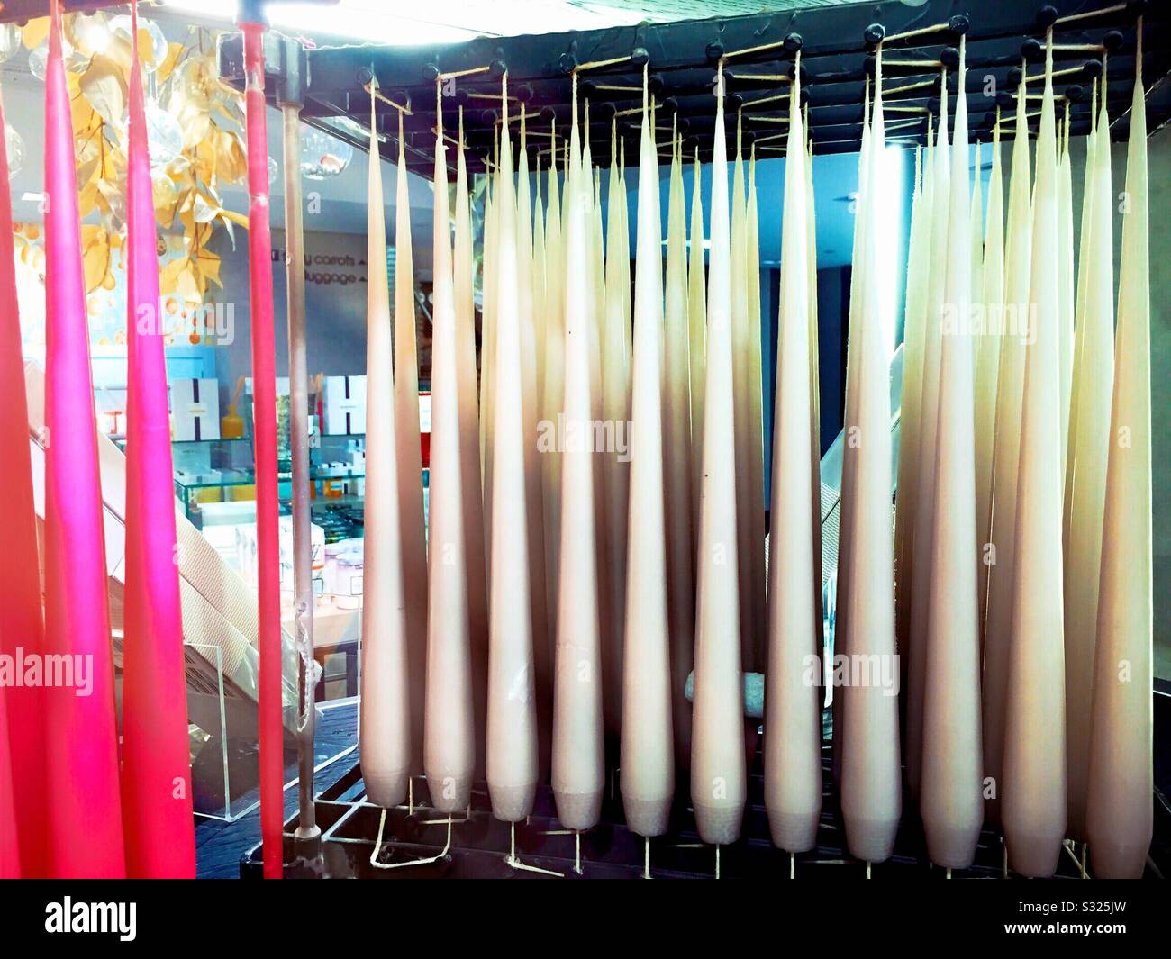 White and pink tapered candles for sale in a retail store, USA - Smartphone Captured Stock Image