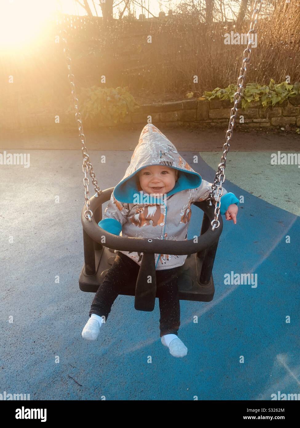 Baby in swing Stock Photo Alamy