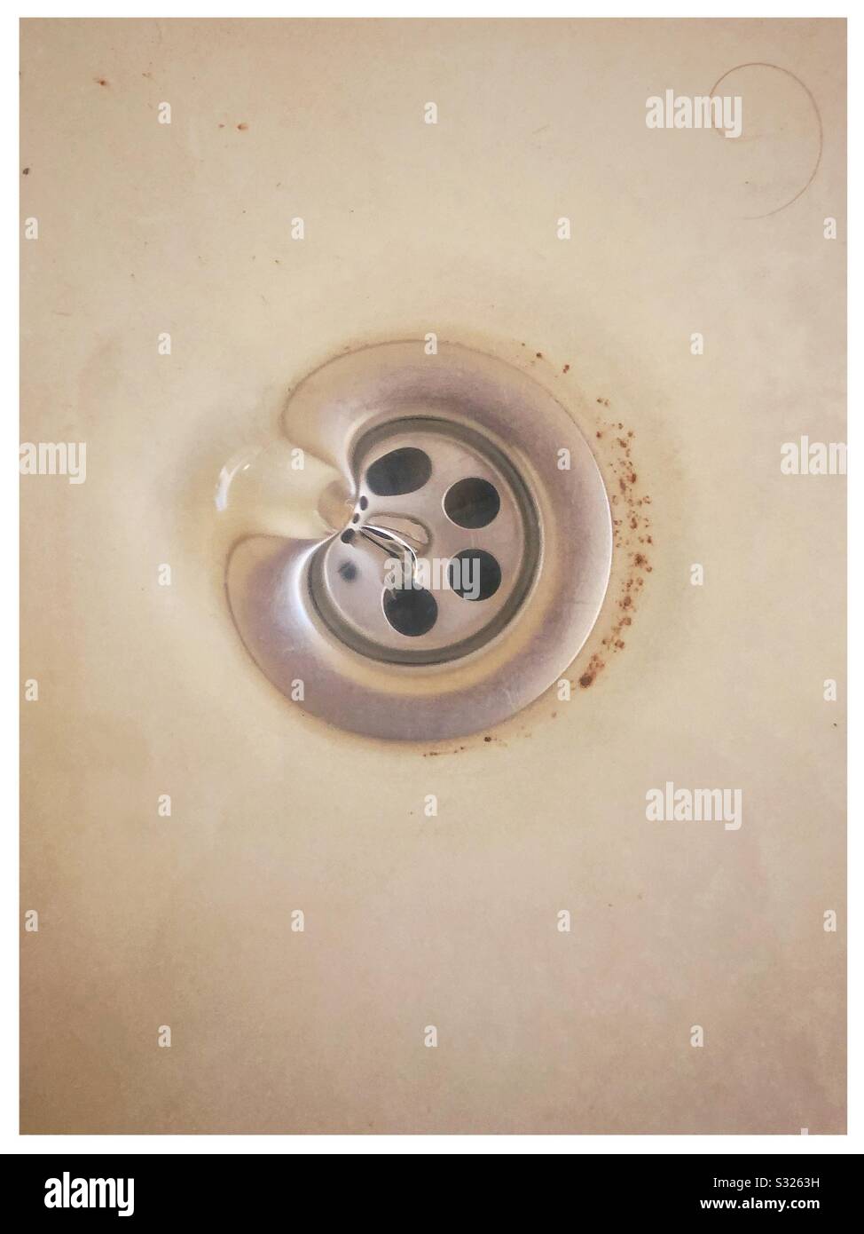 Water draining down an old plug hole in a bath Stock Photo Alamy
