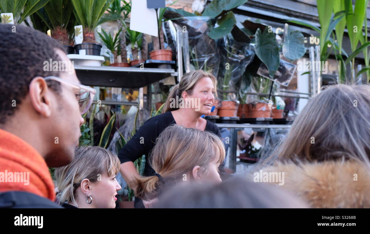 Flower seller and customers in a flower market - Smartphone Captured Stock Image
