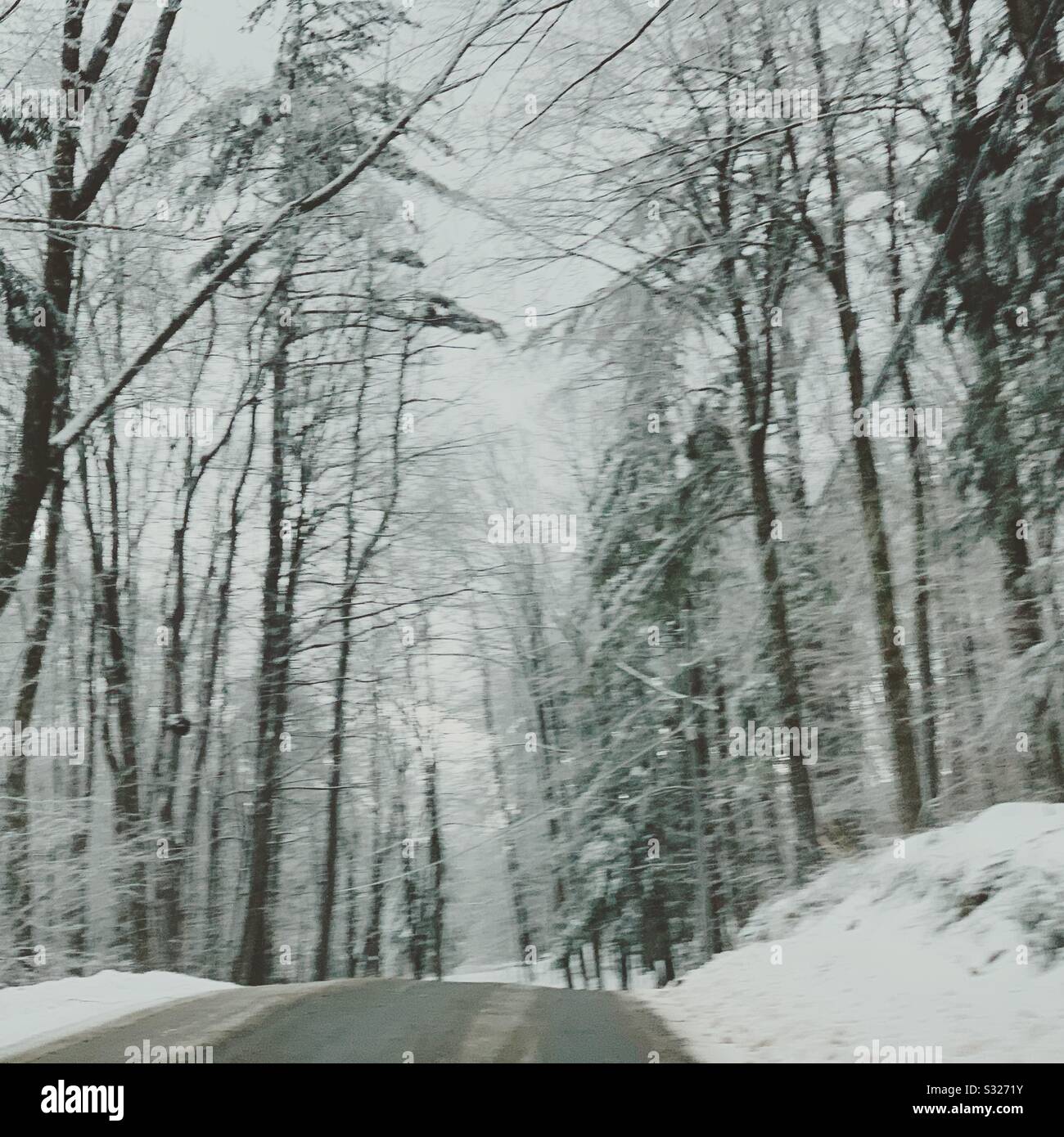Driving on a rural New England road in winter - Smartphone Captured Stock Image