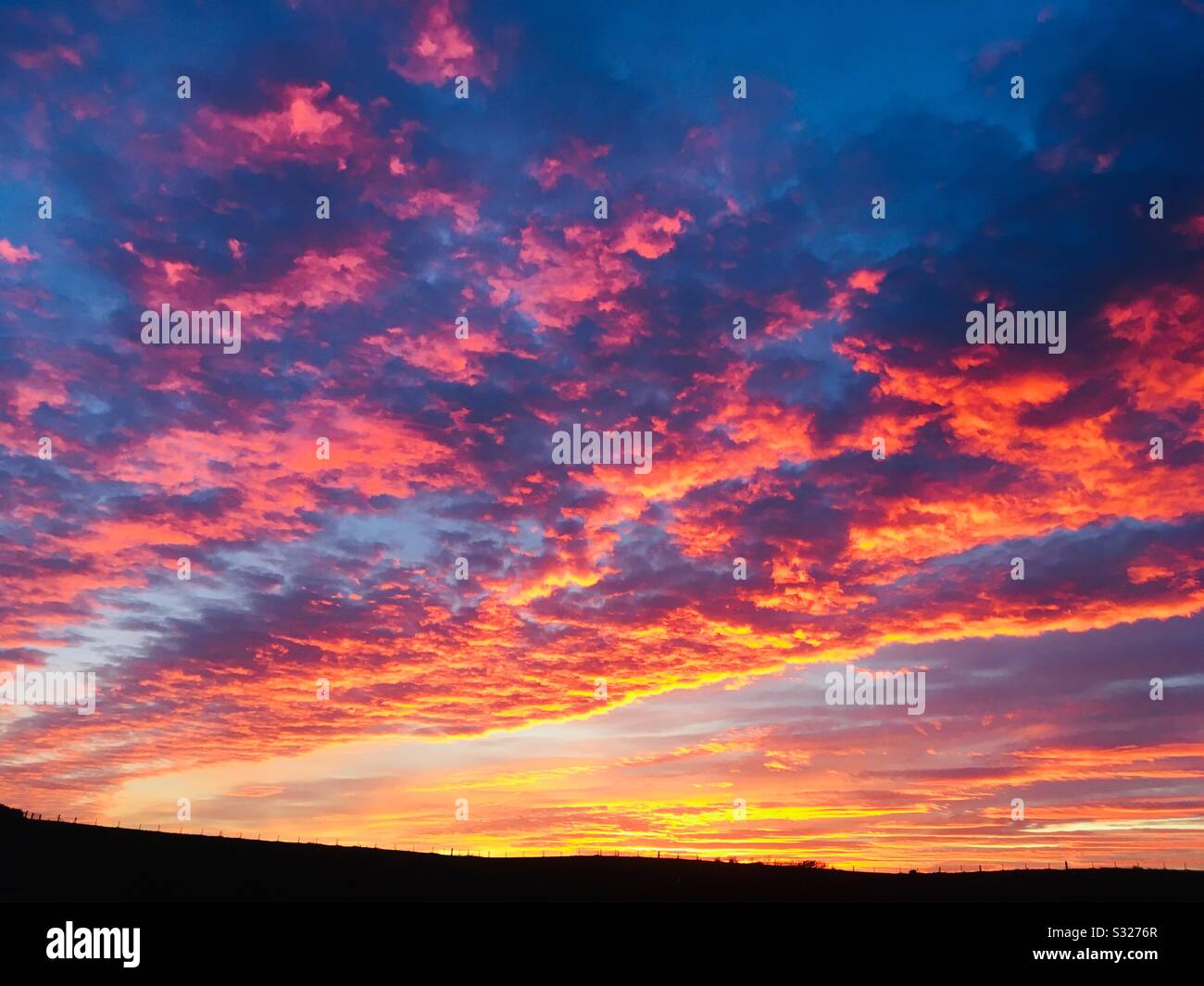 Dramatic Fiery Winter Sunset clouds over the Rhins, Dumfries and Galloway, Scotland Stock Photo