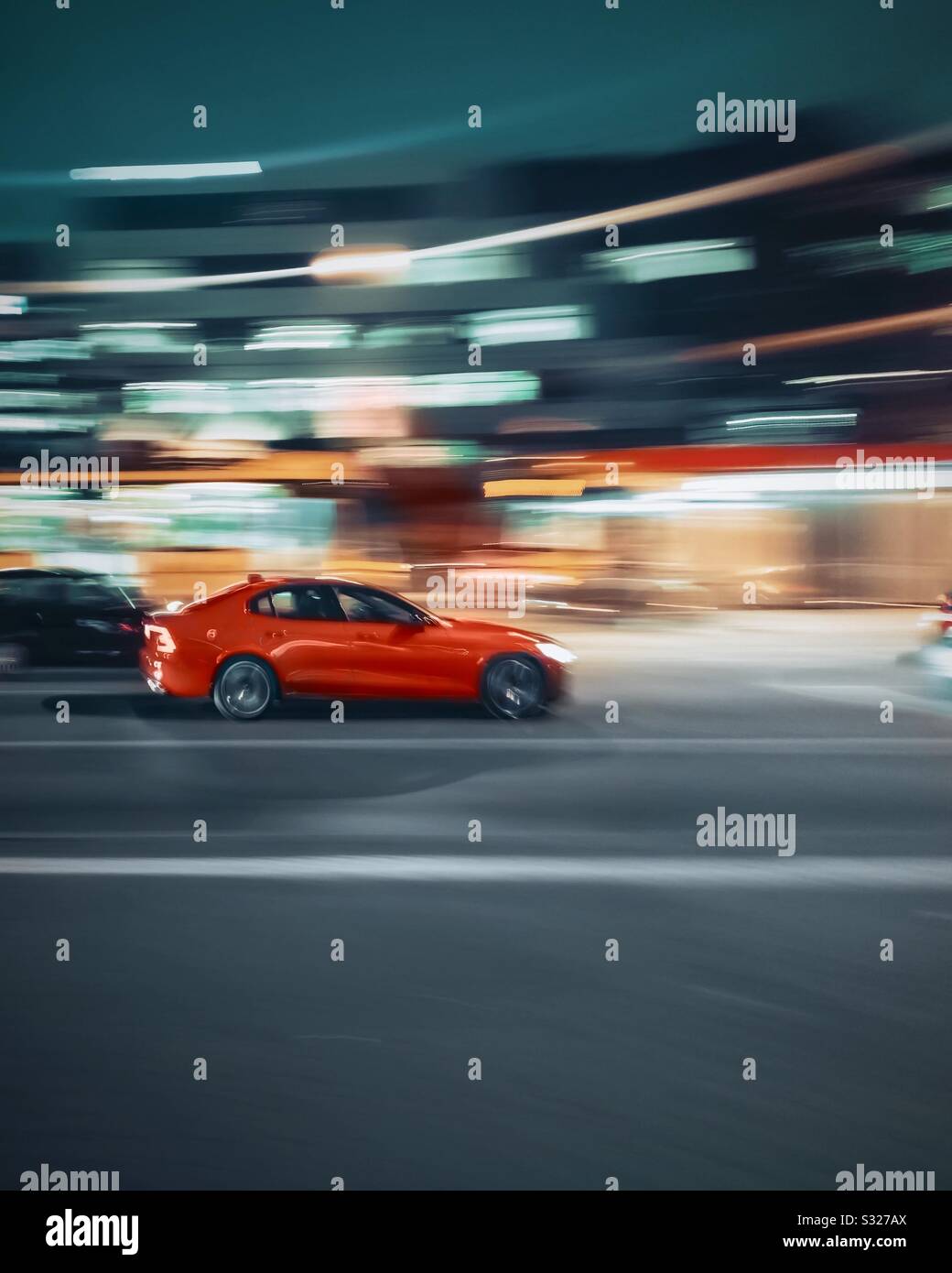 Red car driving fast Stock Photo