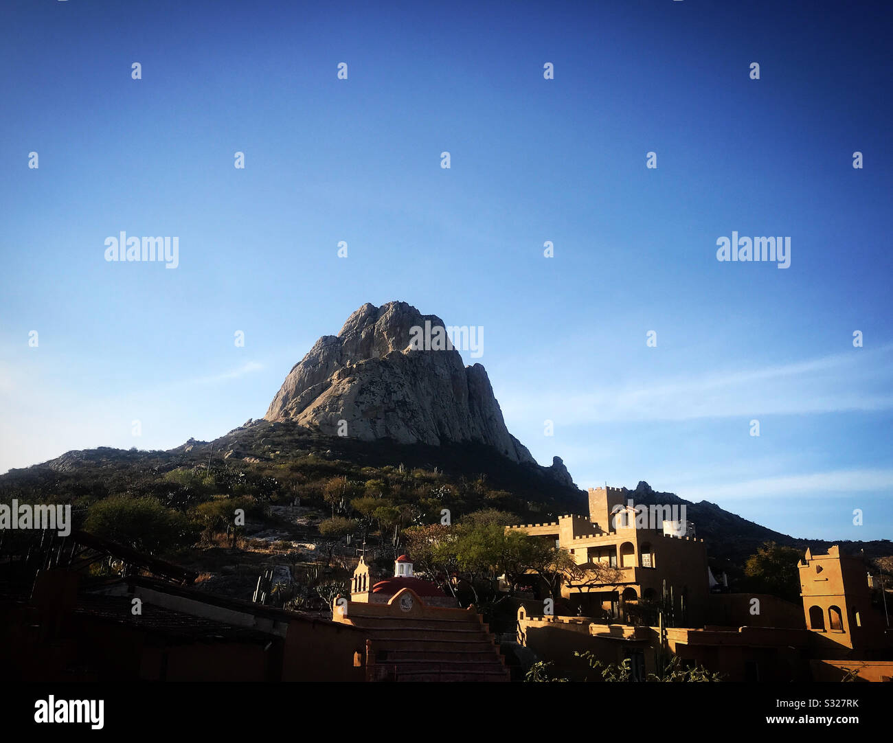 The Hostal Medieval hotel at the Peña de Bernal stone monolite’s slope in San Sebastian Bernal, Queretaro State, Mexico - Smartphone Captured Stock Image