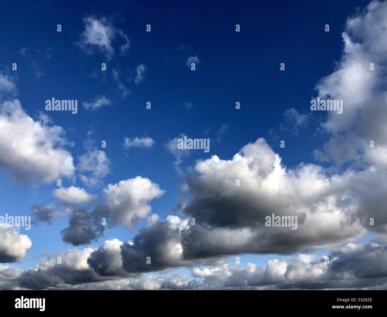 Cumulus clouds against blue sky. Stock Photo