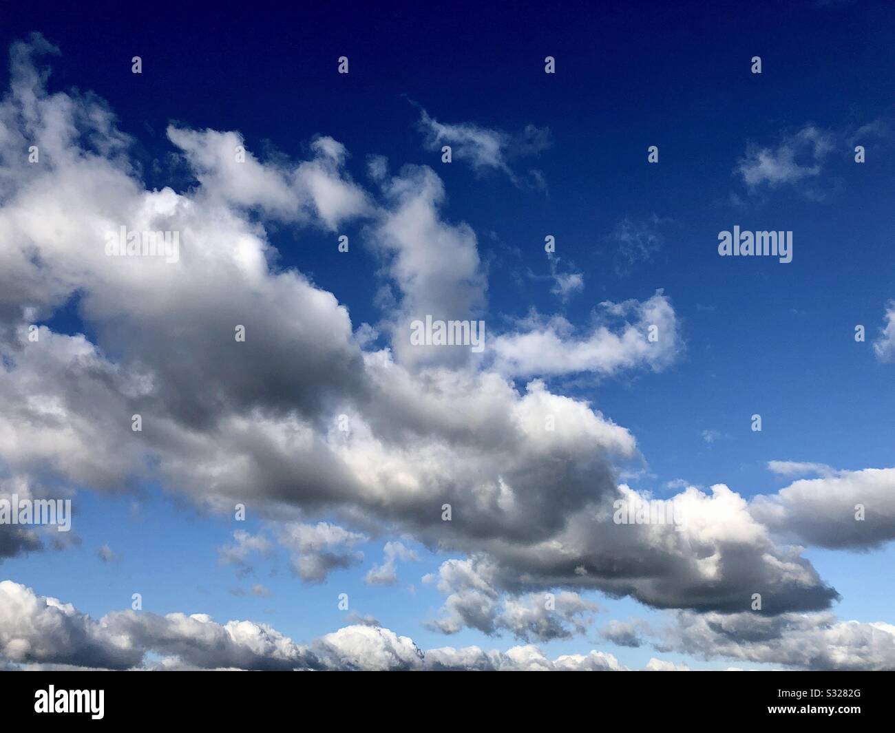 Cumulus clouds against blue sky. - Smartphone Captured Stock Image