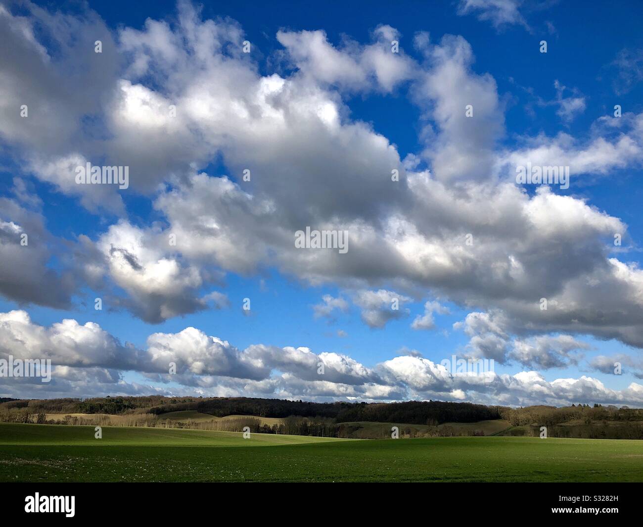 Cumulus clouds over farmland in central France. Stock Photo