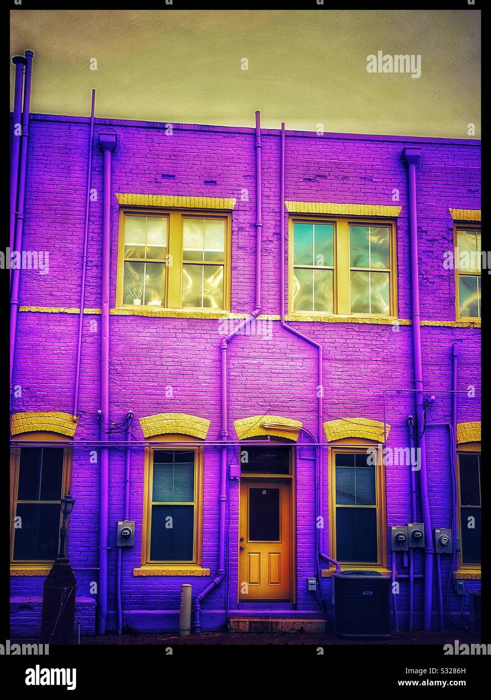 Purple apartment building at twilight Stock Photo