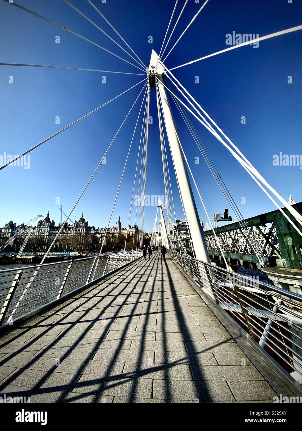 Hungerford bridge from the south bank to the Embankment, On a sunny Midweek afternoon. Stock Photo